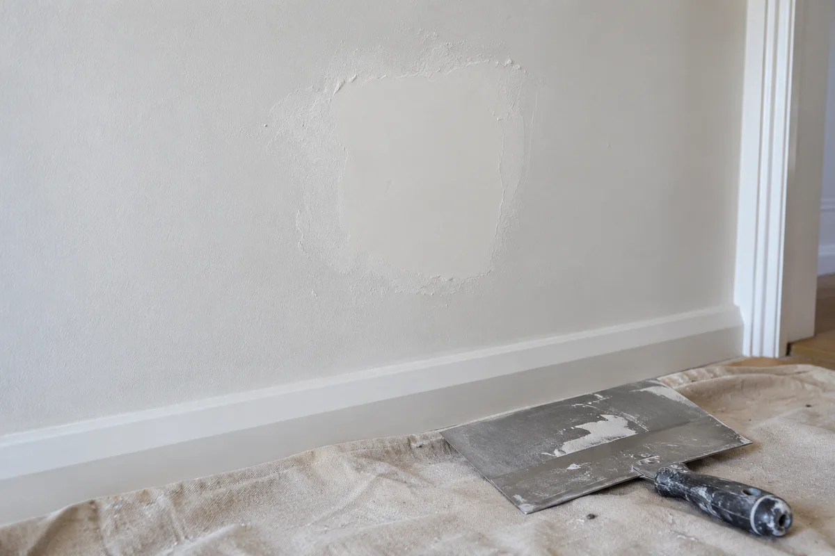 Real plasterboard wall with a small neatly skimmed repair patch