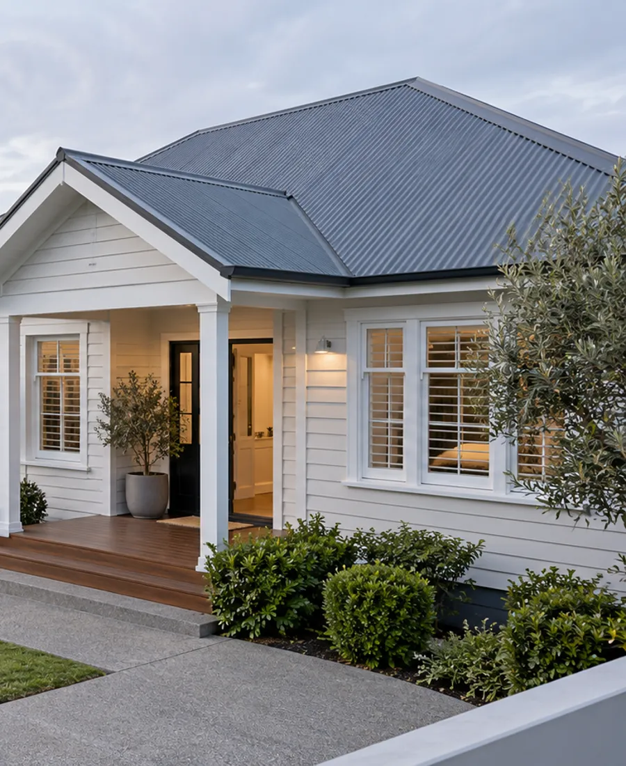 Welcoming Auckland family house with painted timber cladding, attractive metal roof and modest garden